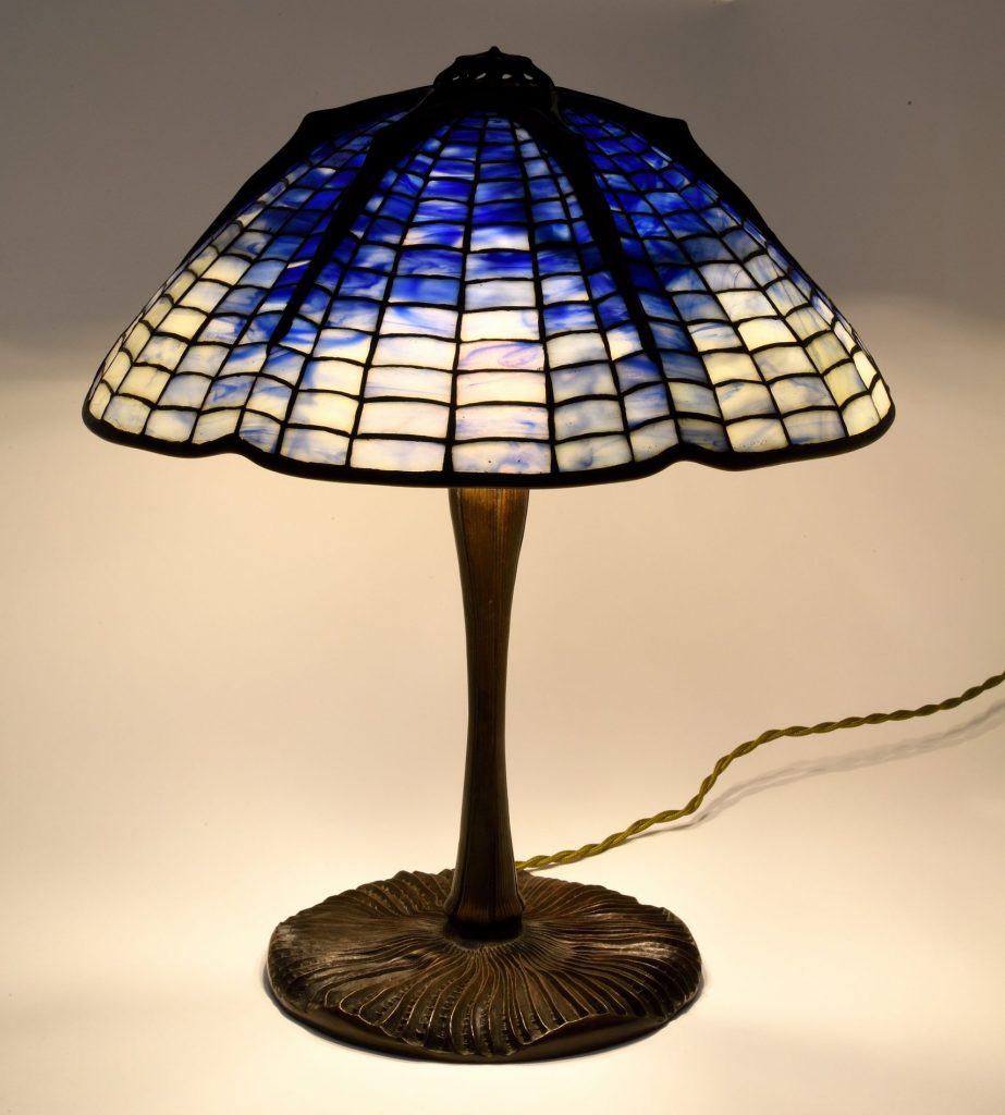 Tiffany lamp with an upturned mushroom base and blue spiderweb design lampshade