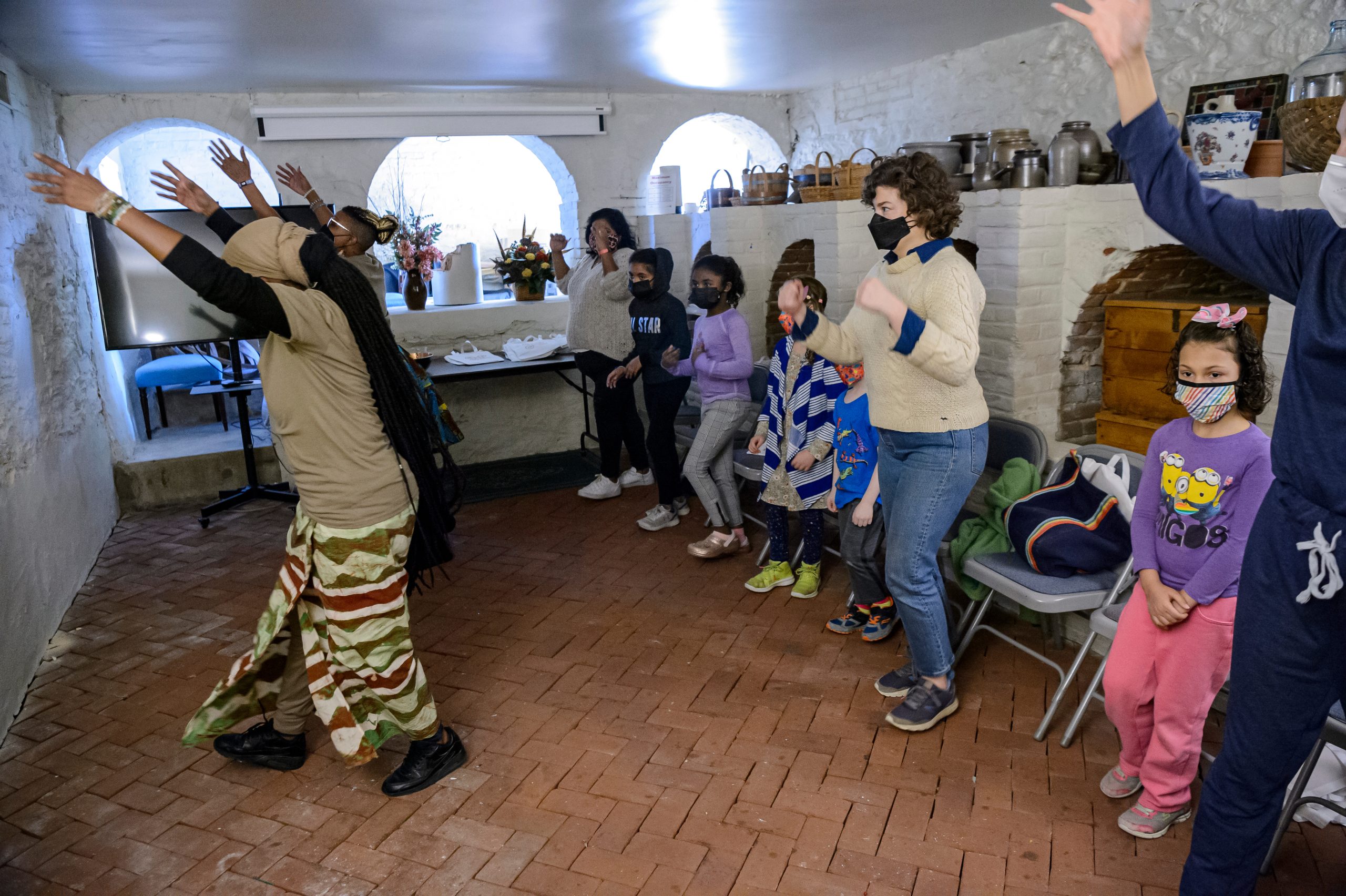 Children and adults dance in Homewood's Wine Cellar.