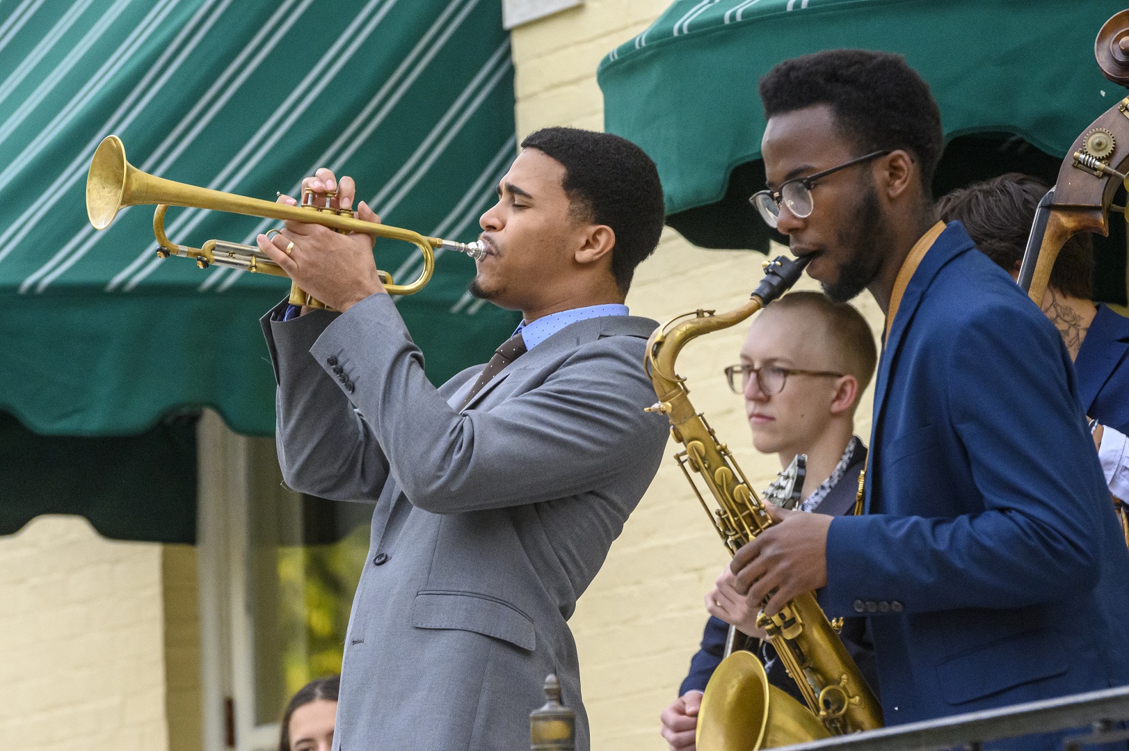 A trumpeter and saxophonist of Kenyatta perform on Evergreen's terrace.
