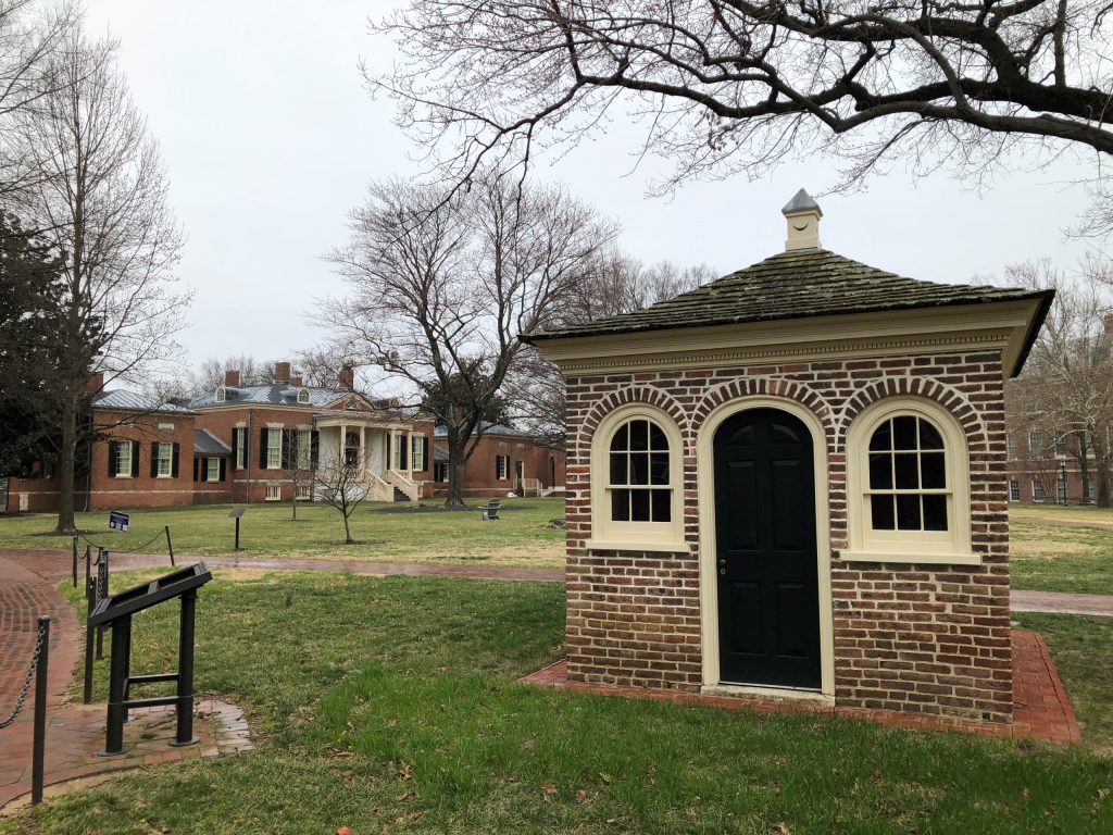 Looking southwest at Homewood's privy, with the main house in the background.